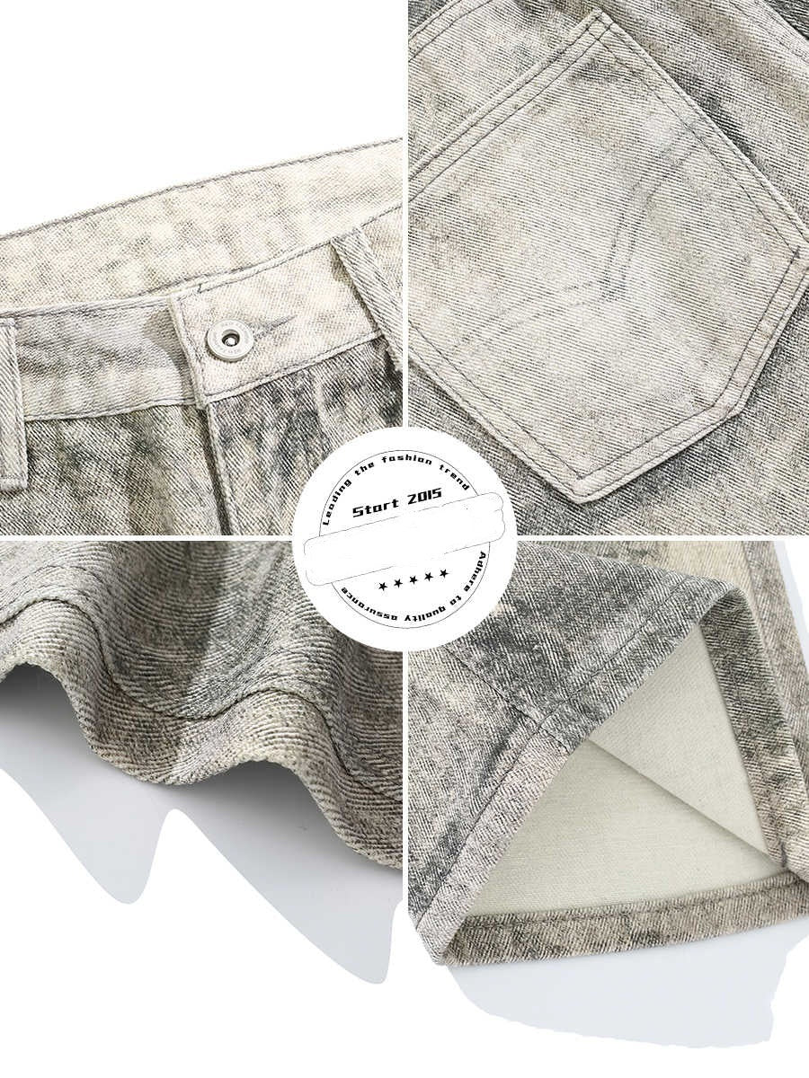 Jeans desgastados con teñidos con un ligero dobladillo de trapeador y agujeros vintage